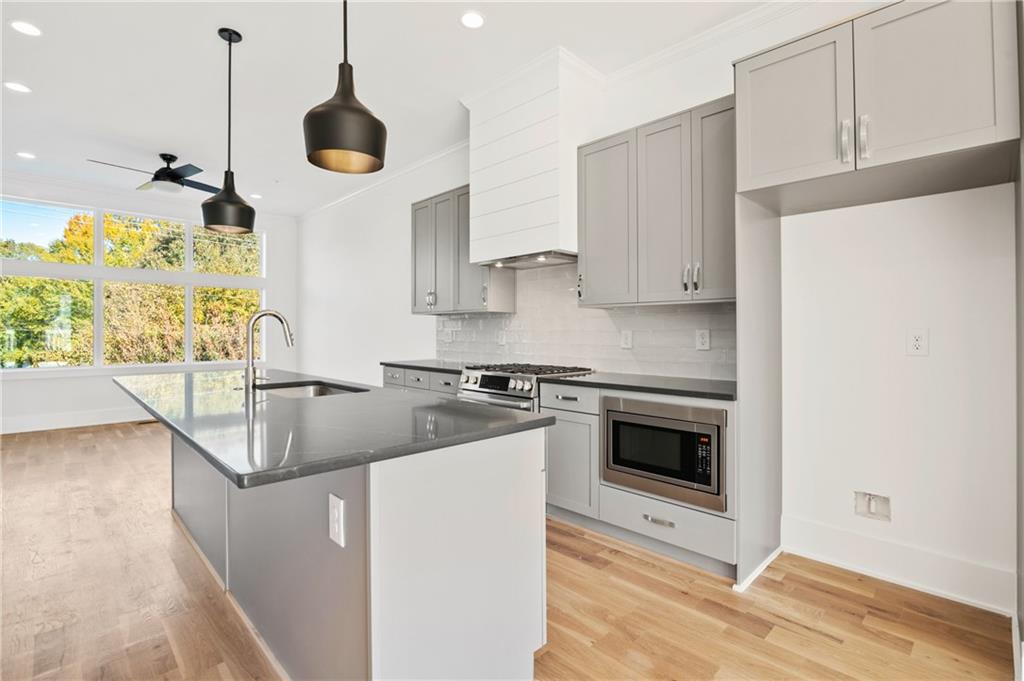 810 West College Avenue Decatur, GA 30030 - Photo 1 of 1 a kitchen with stainless steel appliances granite countertop a sink a stove and a refrigerator
