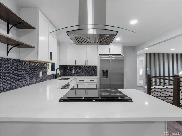 a kitchen with stainless steel appliances granite countertop a sink and cabinets