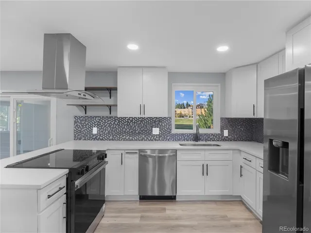 a kitchen with a sink stove and refrigerator