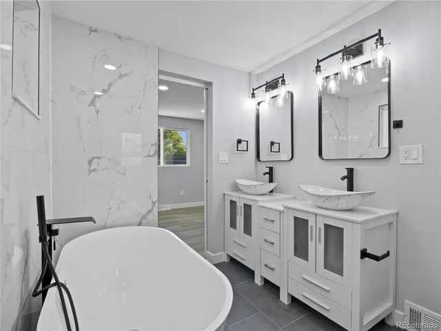a bathroom with a double vanity sink a mirror and shower