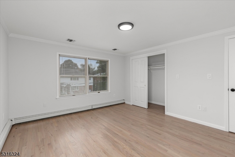 4 Coppola Street Nutley, NJ 07110 - Photo 11 of 14 an empty room with wooden floor and windows