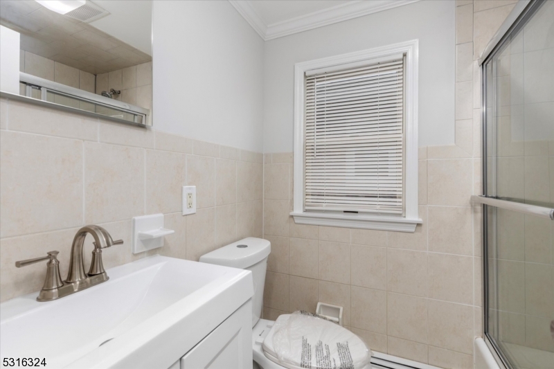 4 Coppola Street Nutley, NJ 07110 - Photo 14 of 14 a bathroom with a sink a toilet and shower