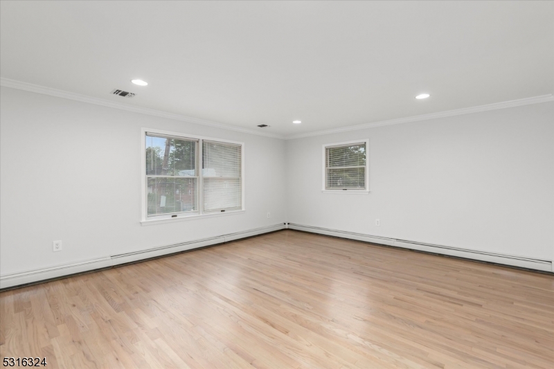 4 Coppola Street Nutley, NJ 07110 - Photo 4 of 14 an empty room with wooden floor and windows