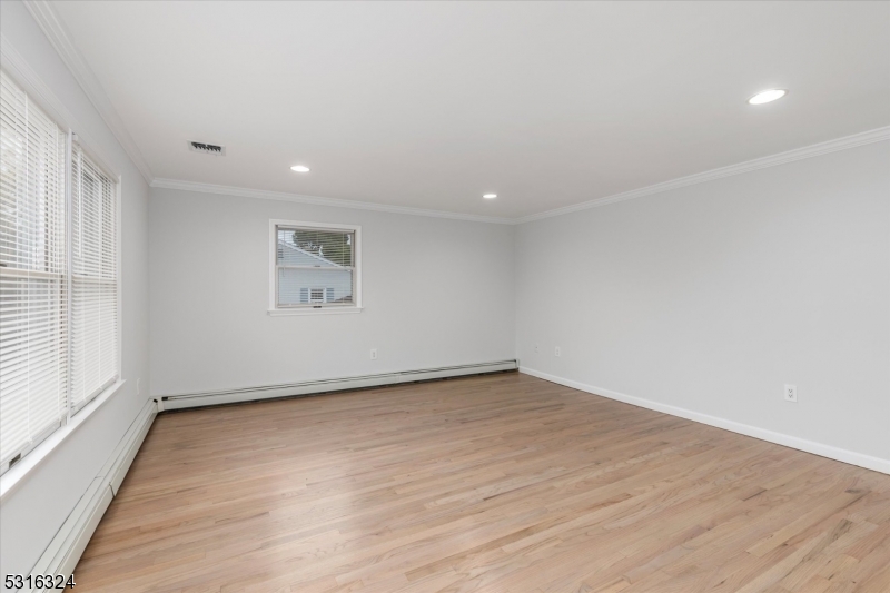 4 Coppola Street Nutley, NJ 07110 - Photo 6 of 14 an empty room with wooden floor and windows