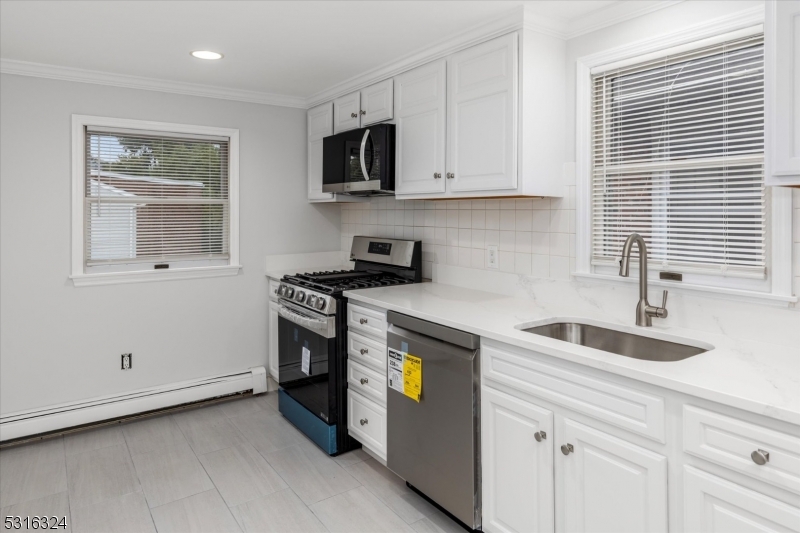 4 Coppola Street Nutley, NJ 07110 - Photo 8 of 14 a kitchen with granite countertop white cabinets and stainless steel appliances