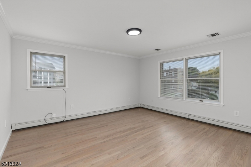 4 Coppola Street Nutley, NJ 07110 - Photo 10 of 14 an empty room with wooden floor and windows