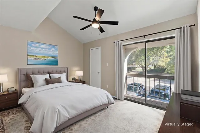 a bedroom with a large bed and a large window