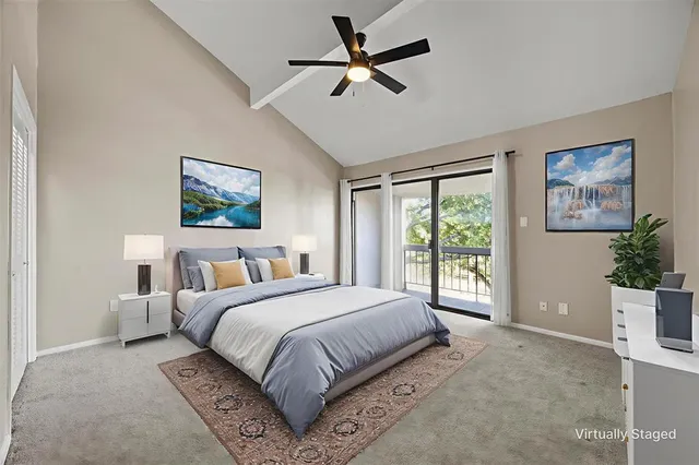 a bedroom with a large bed and a painting on the wall