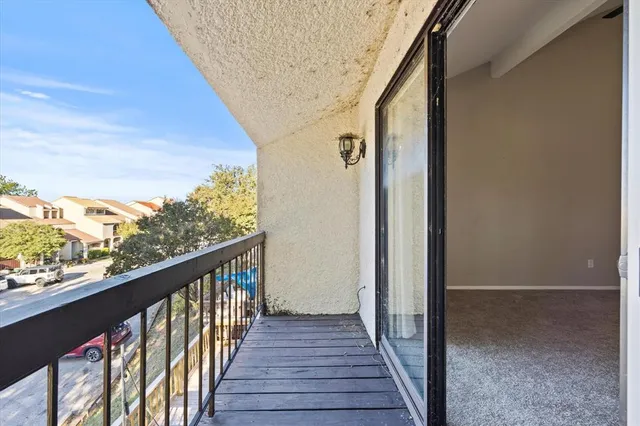 a view of a balcony with wooden floor
