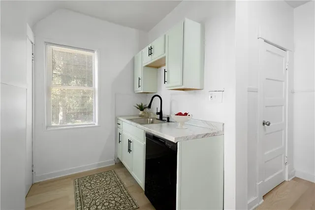 a kitchen with a refrigerator and a stove