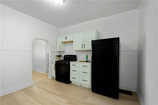 a kitchen with a refrigerator and a stove