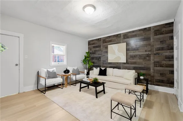 a living room with furniture and a potted plant