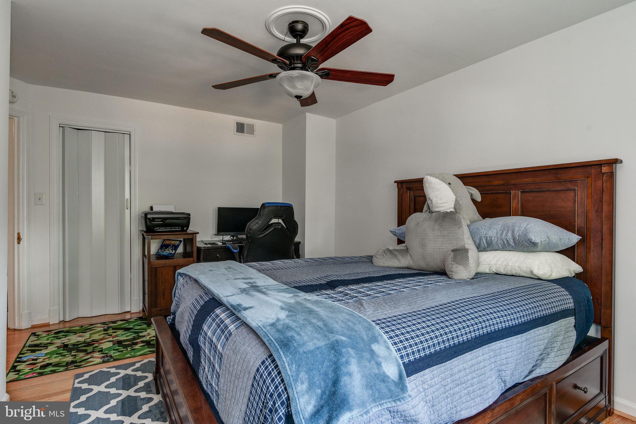 506 Academy Road Baltimore, MD 21228 - Photo 27 of 49 a bedroom with a bed and a chandelier