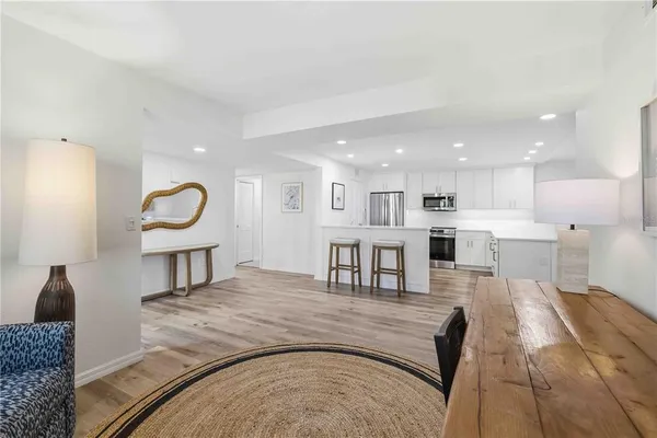 a living room with furniture and kitchen view