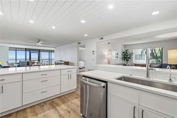 a kitchen with sink and mirror