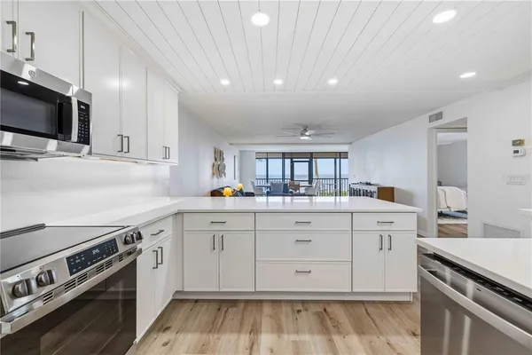a kitchen with a sink stove and microwave