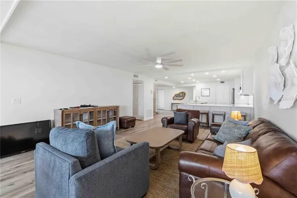 a living room with furniture and wooden floor