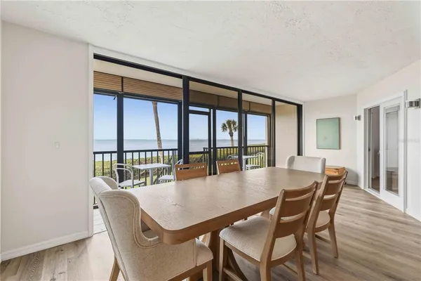 a dining room with furniture window and wooden floor