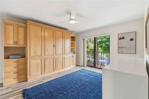 a view of a livingroom with wooden floor and cabinet