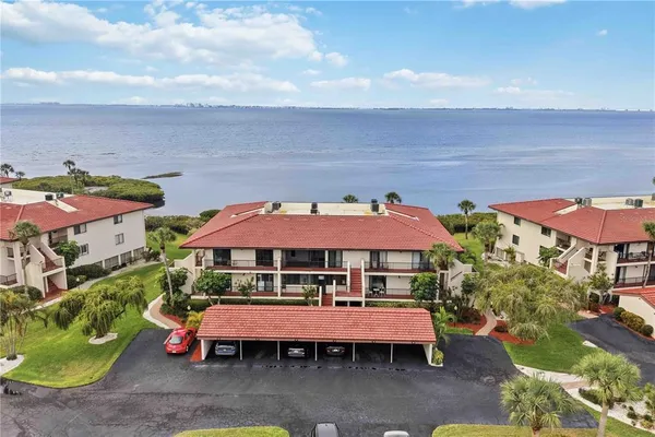 an outdoor space with patio and white umbrellas