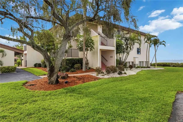 a front view of a house with swimming pool having outdoor seating