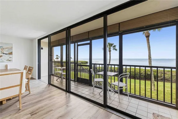 a view of hallway with furniture and wooden floor