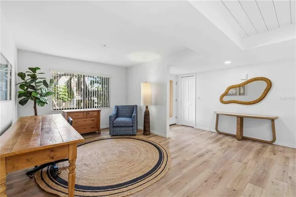 a living room with furniture a window and wooden floor