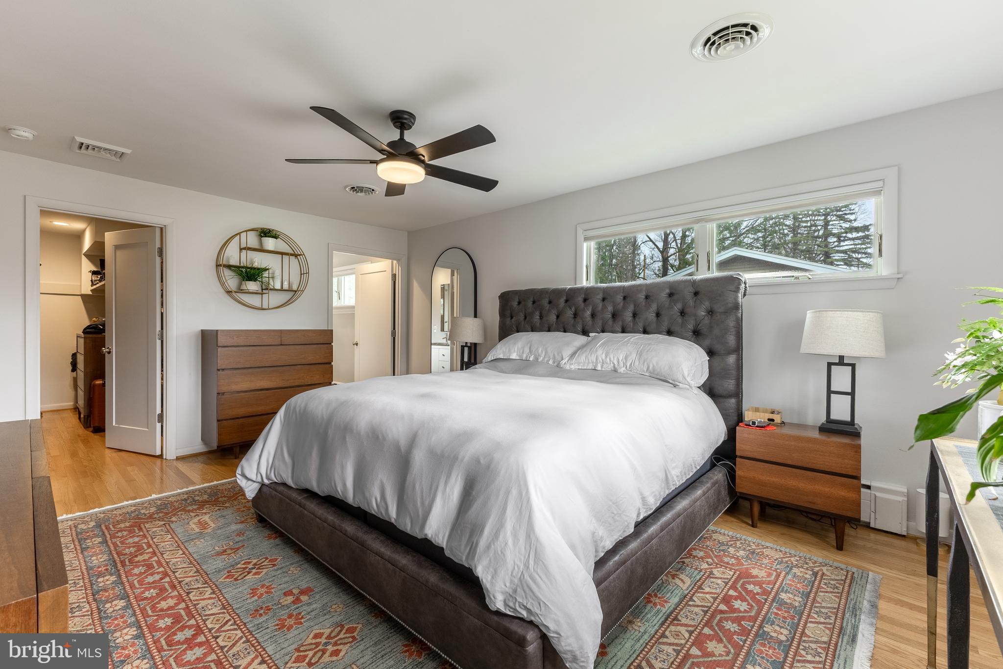 1137 Dorum Avenue State College, PA 16801 - Photo 24 of 56 a spacious bedroom with a bed a chandelier and a dresser