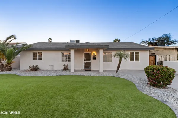 a front view of a house with a garden