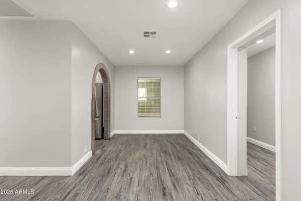 a view of a room with wooden floor and window