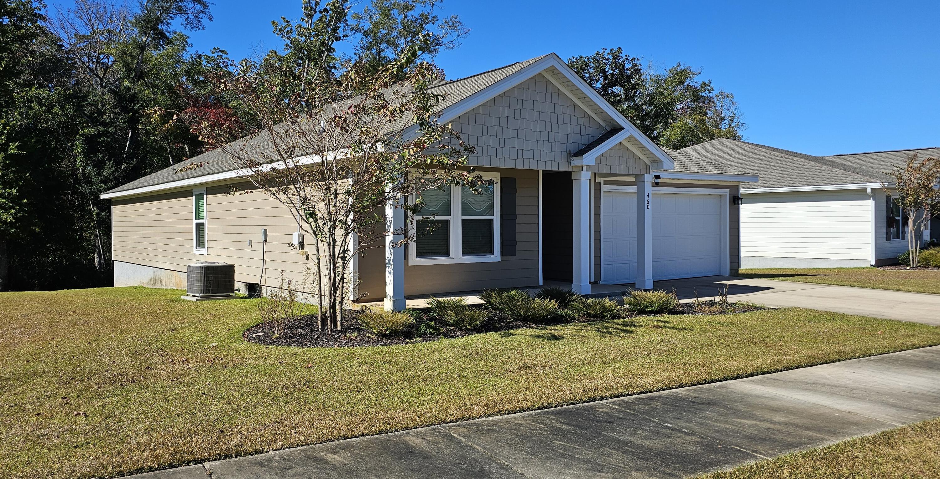 460 Riverwalk Circle Freeport, FL 32439 - Photo 2 of 25 a front view of a house with garden