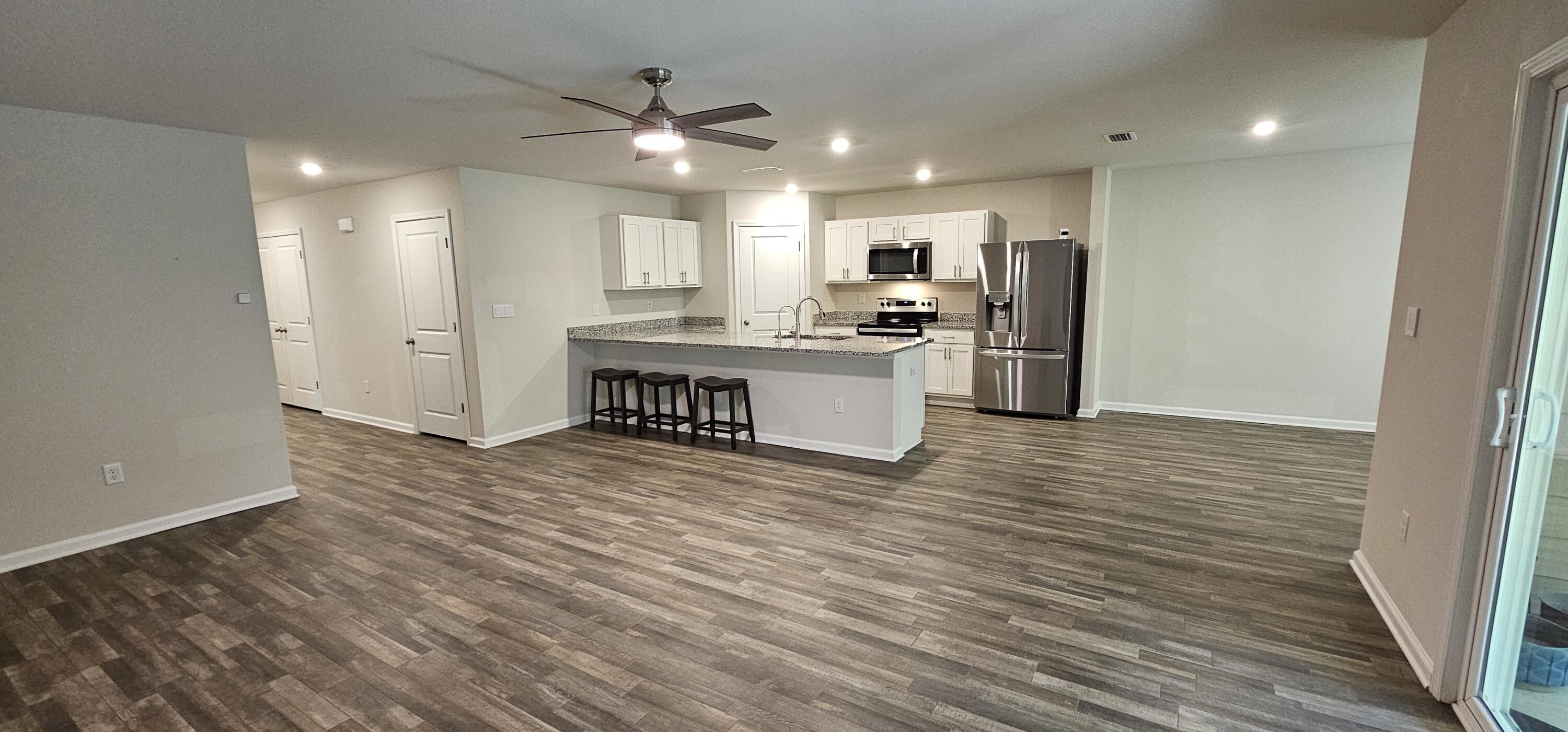 460 Riverwalk Circle Freeport, FL 32439 - Photo 5 of 25 a kitchen with stainless steel appliances a refrigerator and a stove top oven