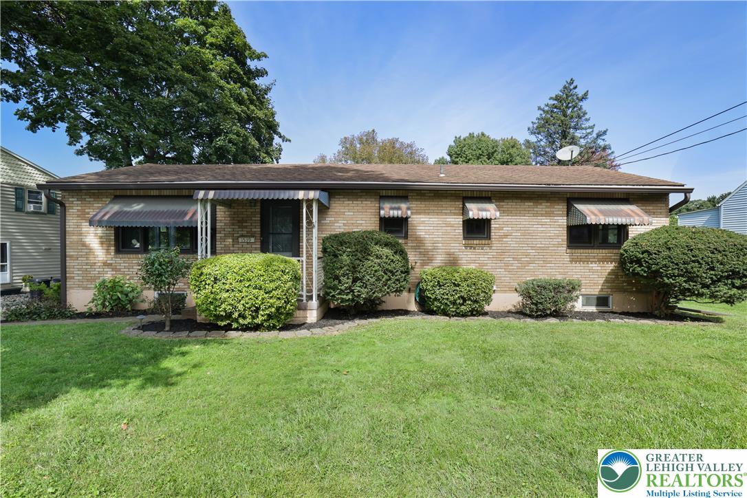 1539 Spring Garden Street Wilson, PA 18042 - Photo 1 of 34 Established brick ranch-style home features awnings over the windows and front entry porch.