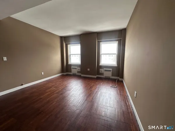 a view of room with window and hardwood floor