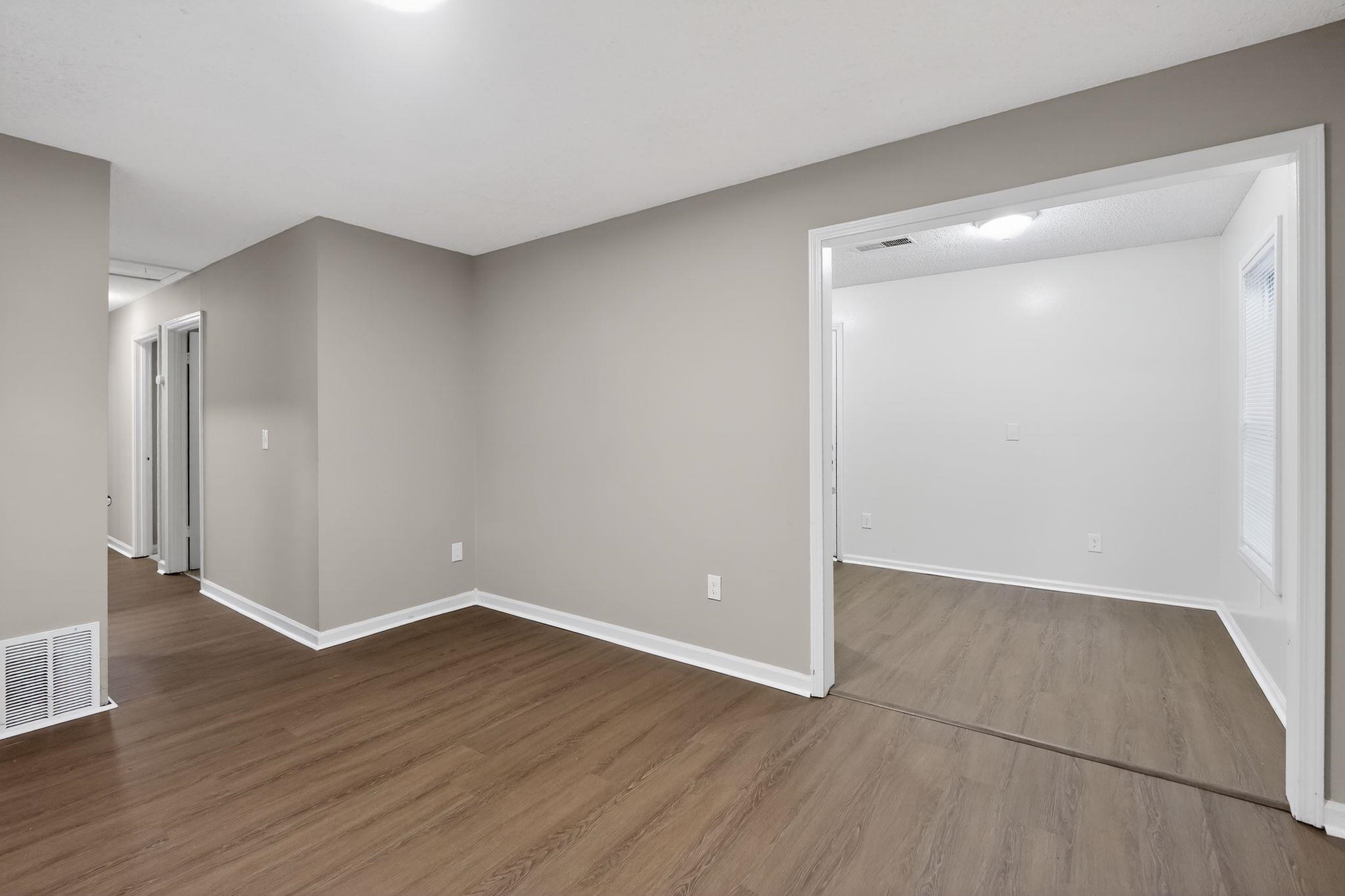 4725 Lofts Road Memphis, TN 38118 - Photo 10 of 32 Empty room featuring baseboards and dark wood-style flooring