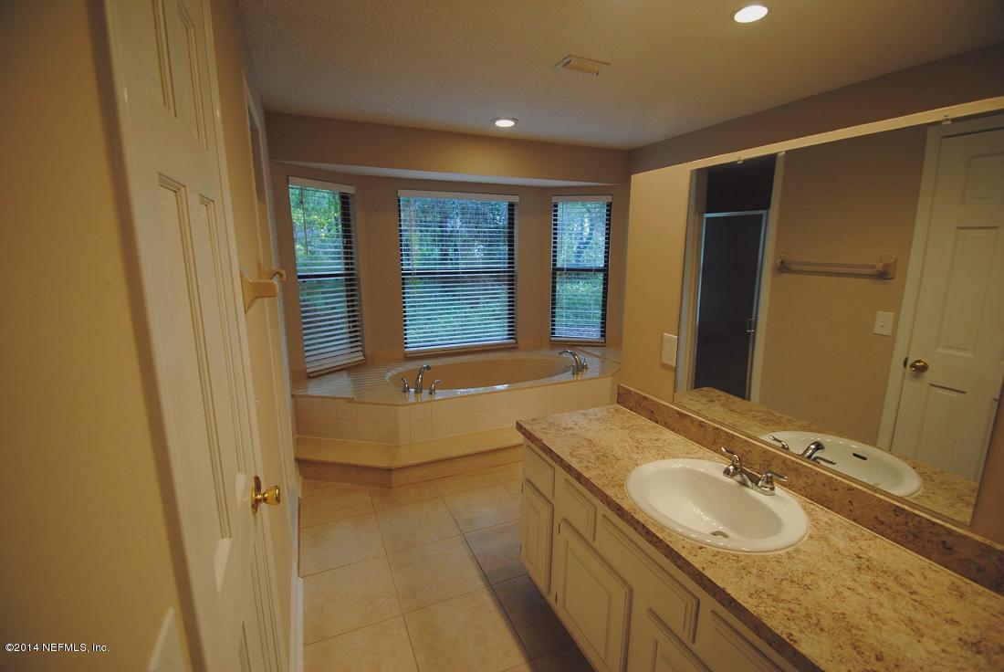 11331 Scott Mill Road Jacksonville, FL 32223 - Photo 11 of 19 a bathroom with a granite countertop sink and large mirror