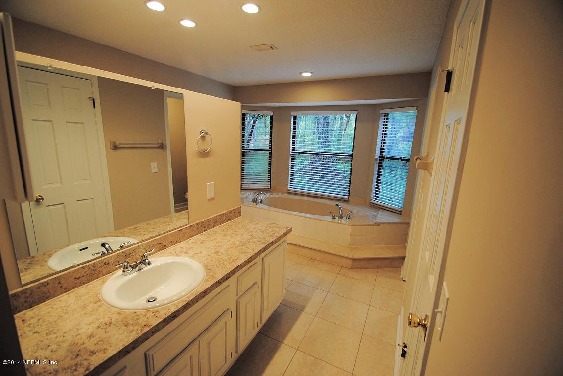 11331 Scott Mill Road Jacksonville, FL 32223 - Photo 12 of 19 a bathroom with a granite countertop sink mirror and a bathtub