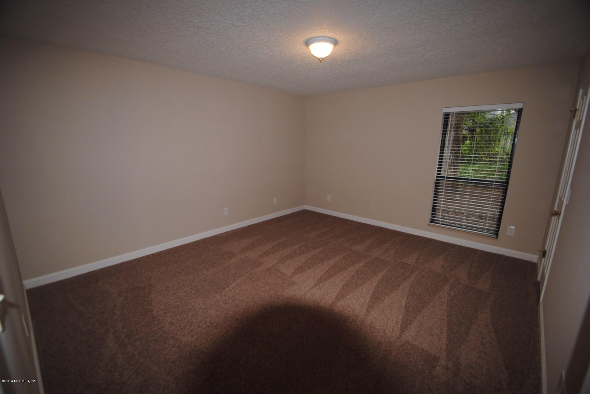 11331 Scott Mill Road Jacksonville, FL 32223 - Photo 13 of 19 a view of an empty room with a window