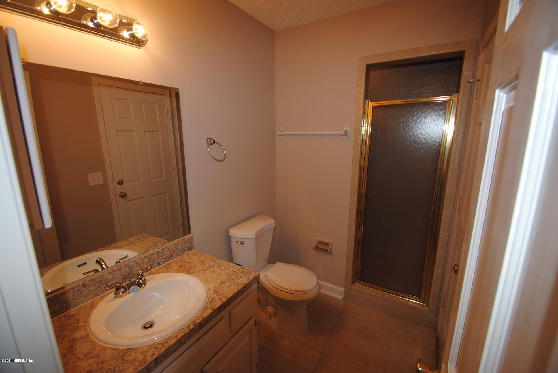 11331 Scott Mill Road Jacksonville, FL 32223 - Photo 6 of 19 a bathroom with a sink a toilet and shower