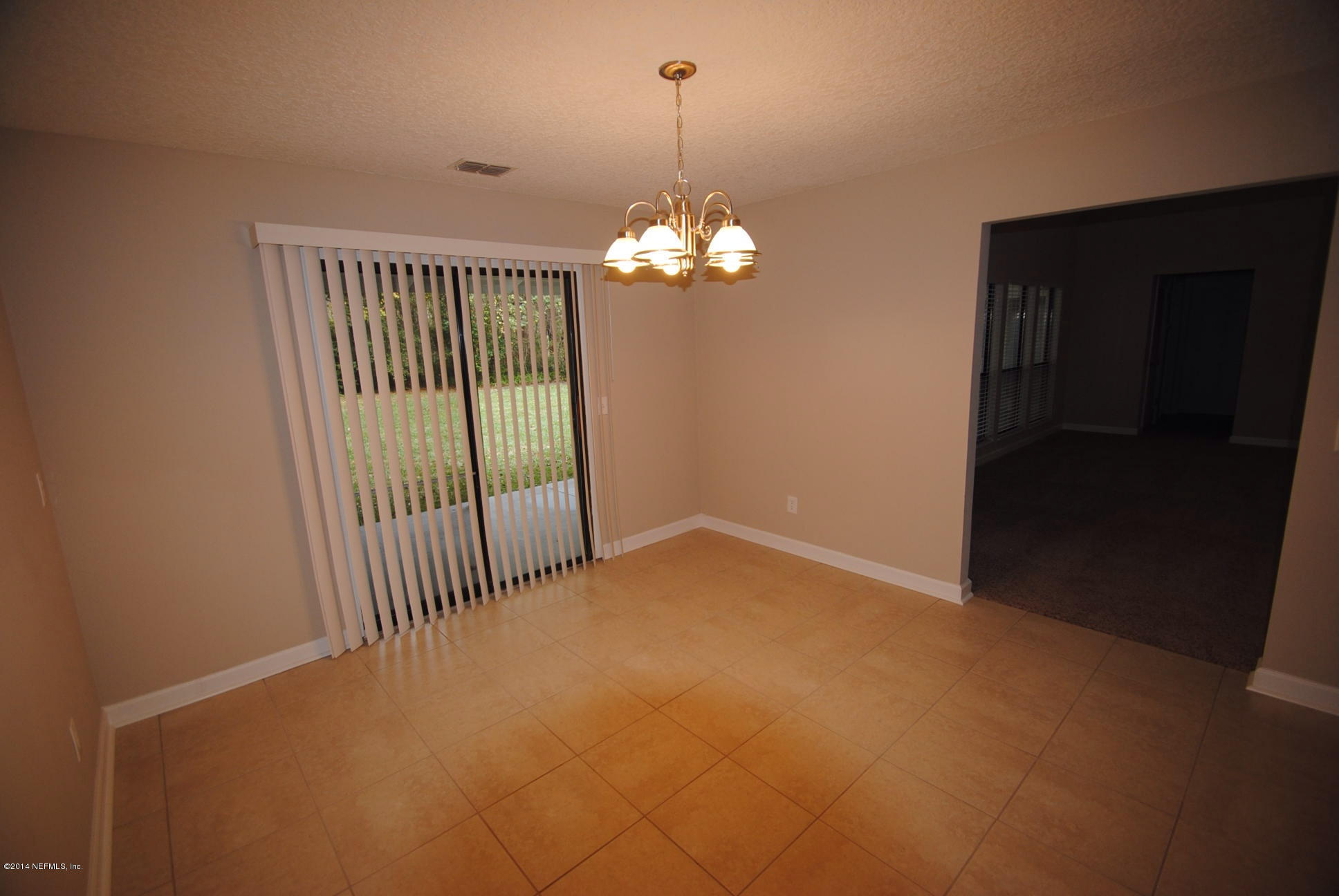 11331 Scott Mill Road Jacksonville, FL 32223 - Photo 8 of 19 a view of a chandelier in big room and chandelier fan
