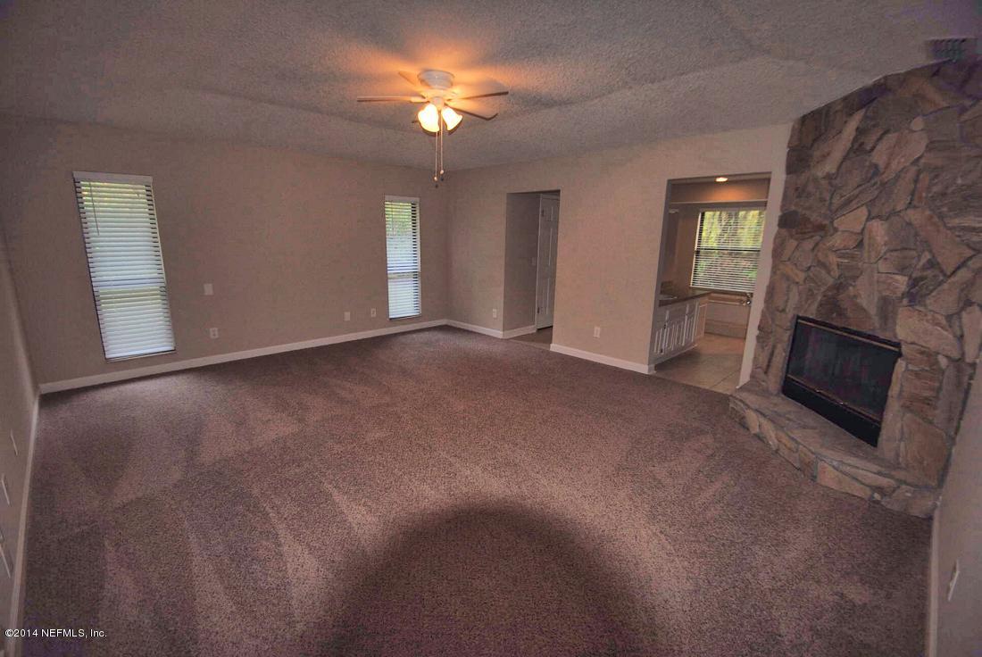 11331 Scott Mill Road Jacksonville, FL 32223 - Photo 10 of 19 a view of empty room with a fireplace