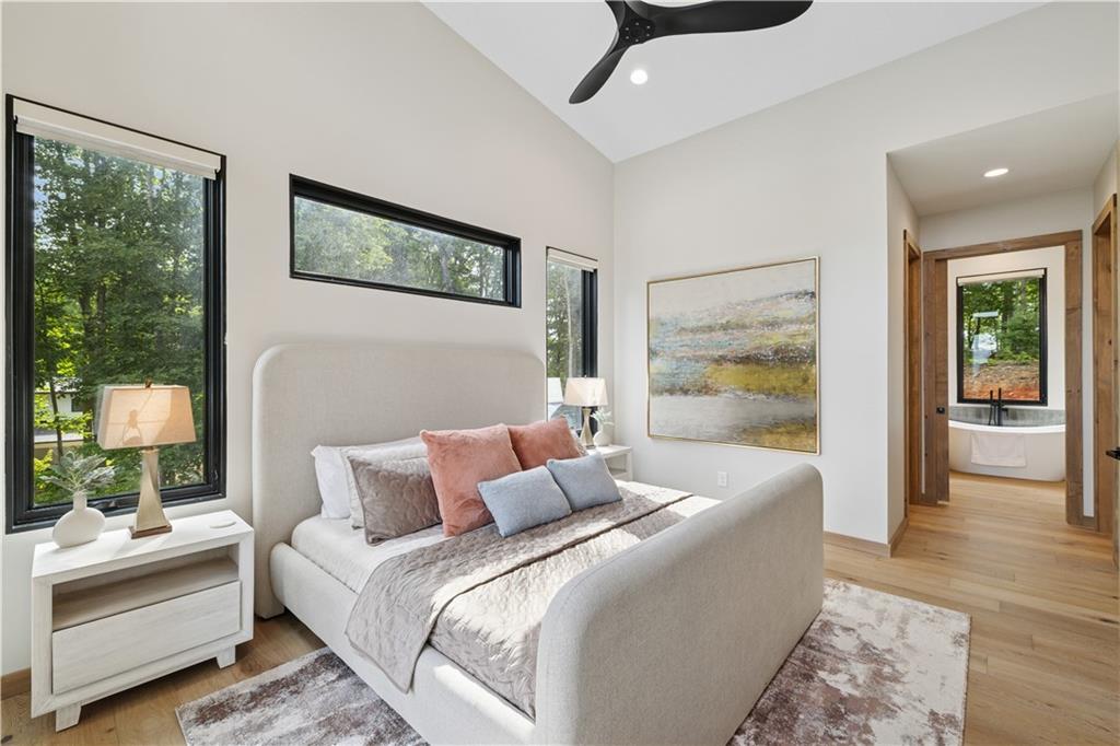 714 Scouts Overlook Lane Morganton, GA 30560 - Photo 21 of 48 a bedroom with a large bed and a couch