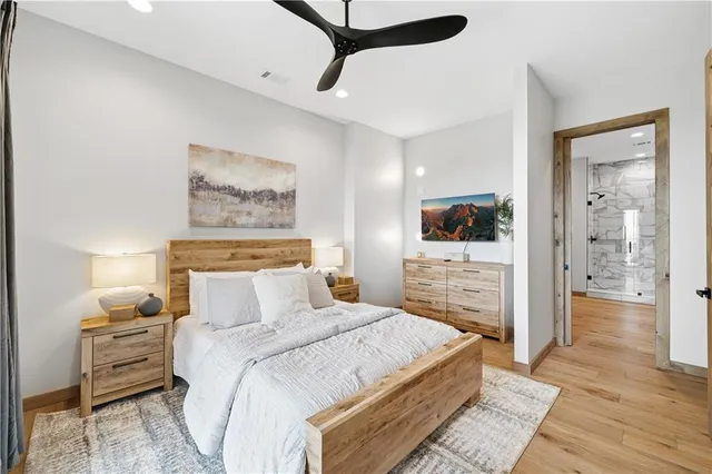 a living room with furniture a fireplace and a floor to ceiling window
