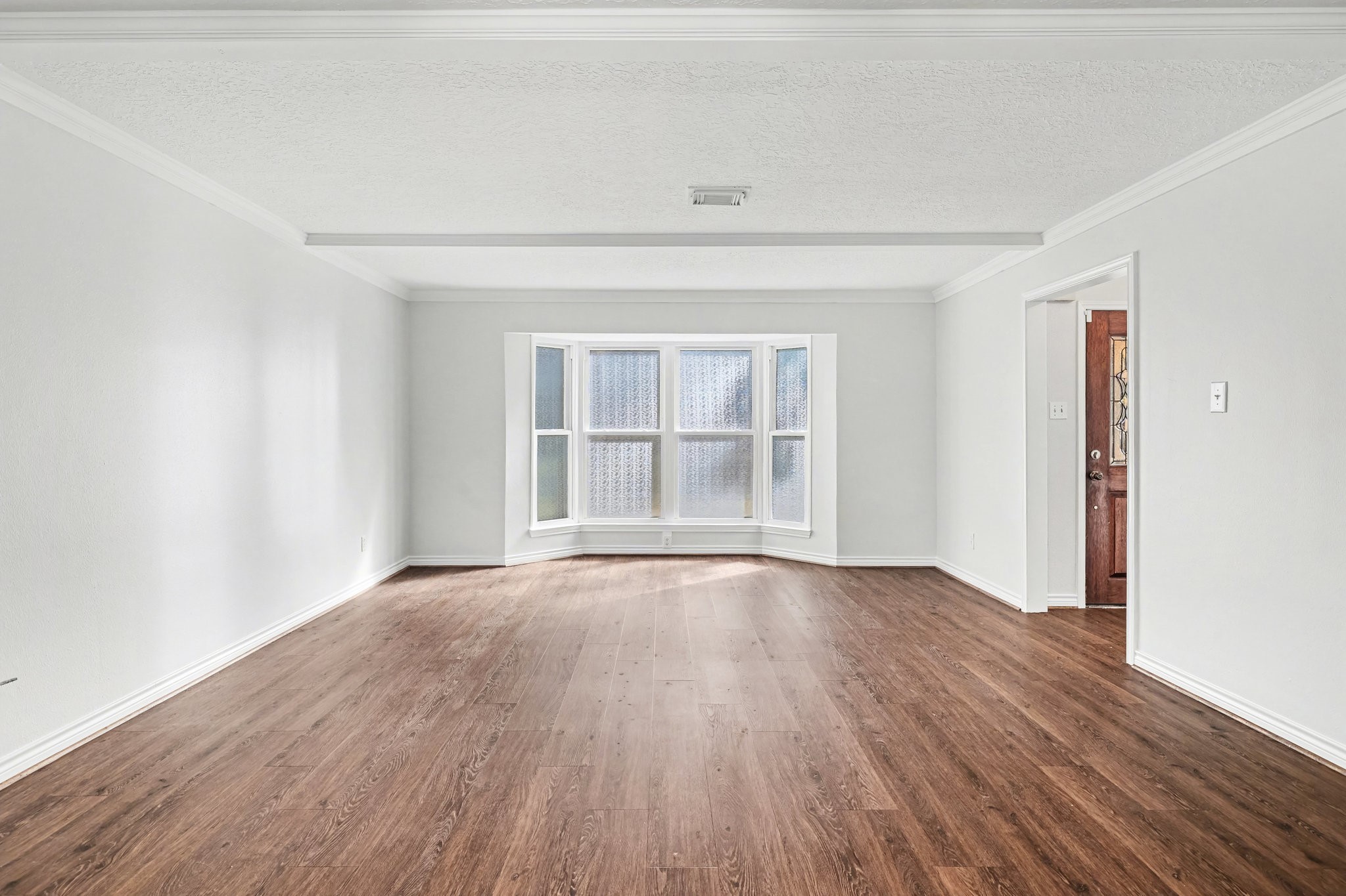6910 Chancellor Drive Spring, TX 77379 - Photo 12 of 41 an empty room with wooden floor and windows