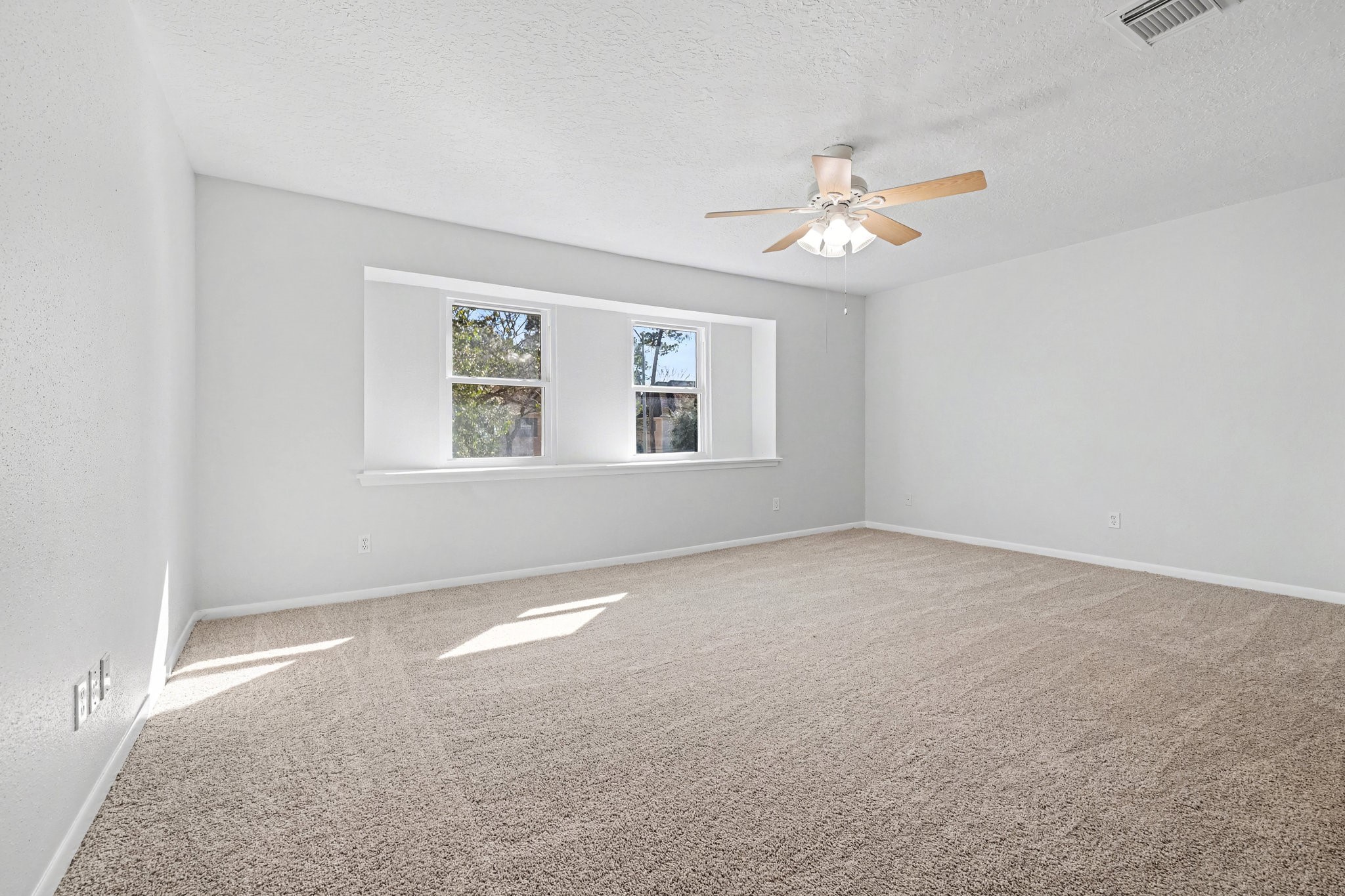 6910 Chancellor Drive Spring, TX 77379 - Photo 19 of 41 an empty room with a window and a fan