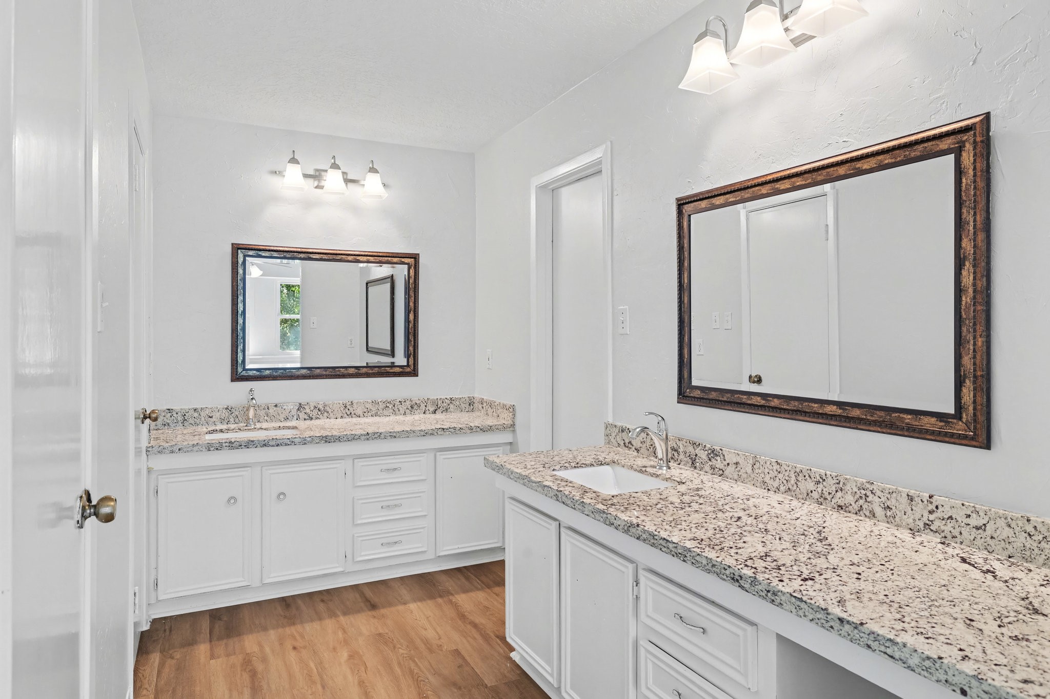 6910 Chancellor Drive Spring, TX 77379 - Photo 22 of 41 a bathroom with a granite countertop sink and a mirror