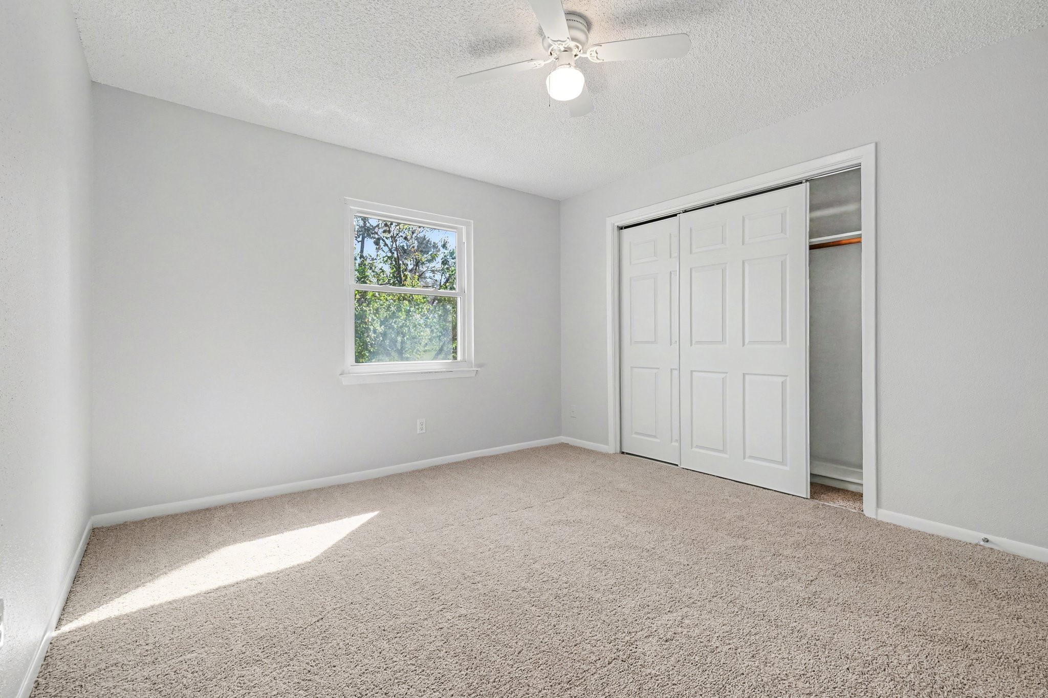 6910 Chancellor Drive Spring, TX 77379 - Photo 30 of 41 an empty room with windows and fan