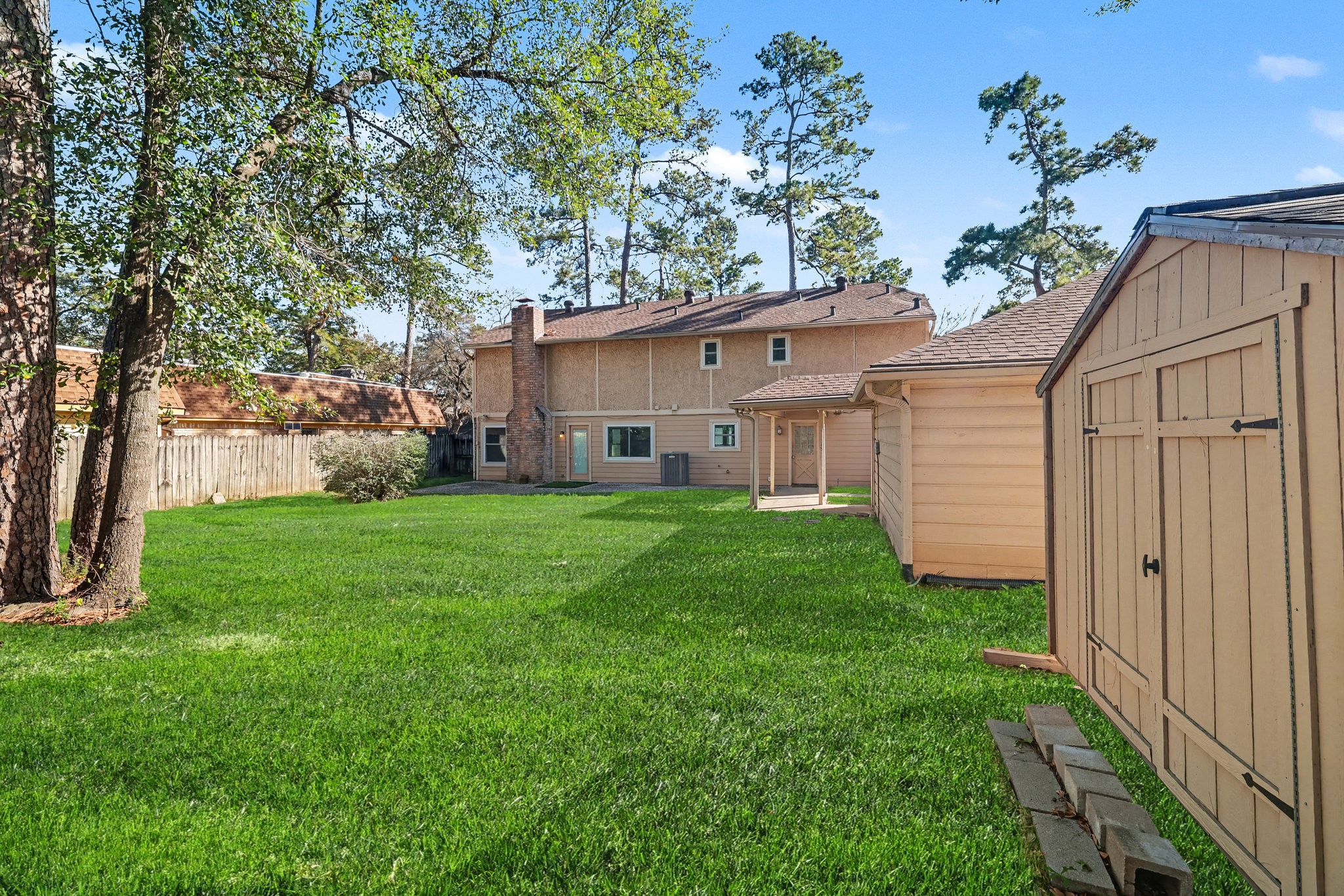 6910 Chancellor Drive Spring, TX 77379 - Photo 33 of 41 a view of a house with yard and a tree