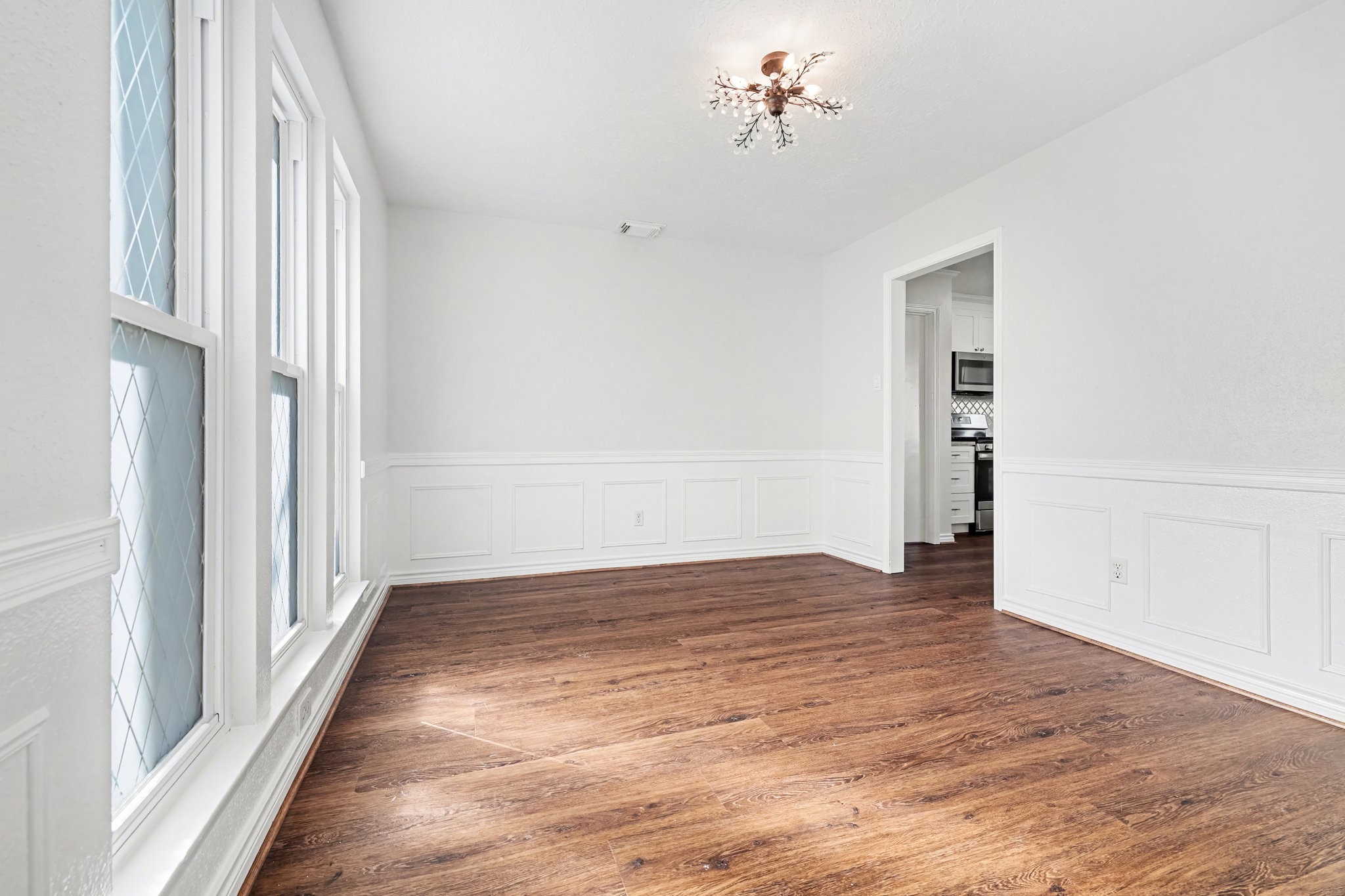 6910 Chancellor Drive Spring, TX 77379 - Photo 6 of 41 a view of empty room with wooden floor and fan