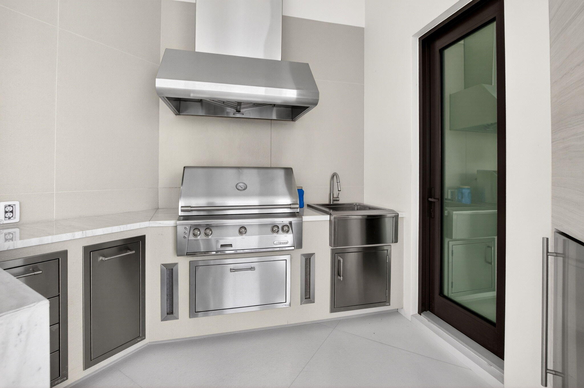 6960 Lake Estates Court Boca Raton, FL 33496 - Photo 52 of 58 a kitchen with white cabinets and a stainless steel refrigerator stove